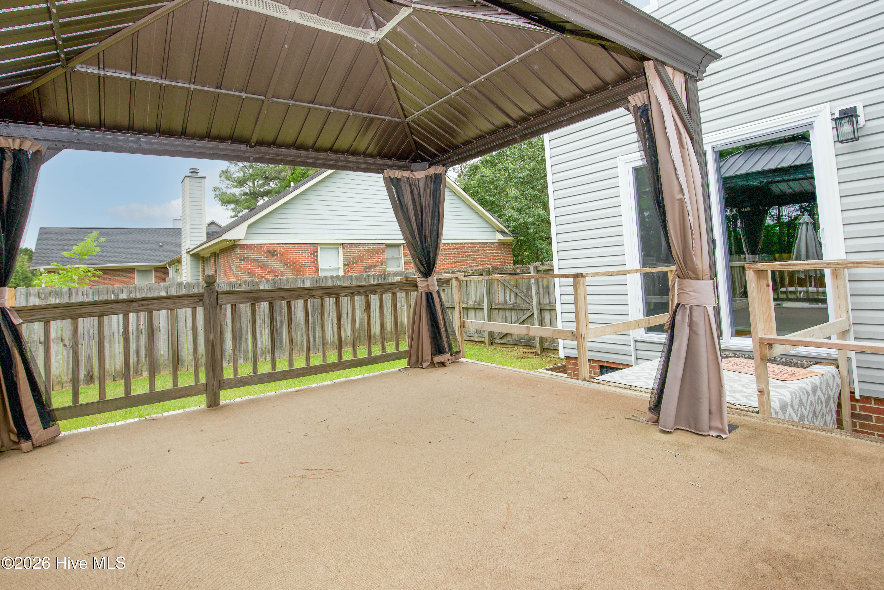 Covered gazebo and elevated outdoor entertaining area overlooking the backyard retreat and pool space. This flexible outdoor living area provides shade, comfort, and additional gathering space ideal for cookouts, watching the game, relaxing after work, or entertaining guests throughout the year. Outdoor lifestyle features like this are increasingly sought after among Fayetteville and Fort Bragg area buyers looking for homes designed for both everyday living and entertaining.