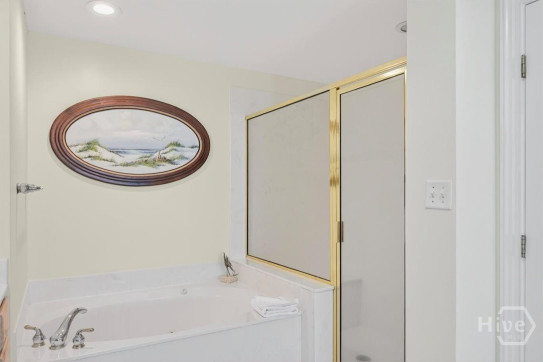Huge primary en-suite offers ample closet space, a soaking tub, double vanities, and separate shower