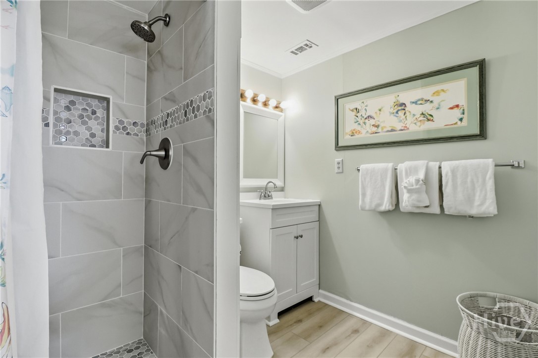 MODERN TILE BATH WITH WALKIN SHOWER.