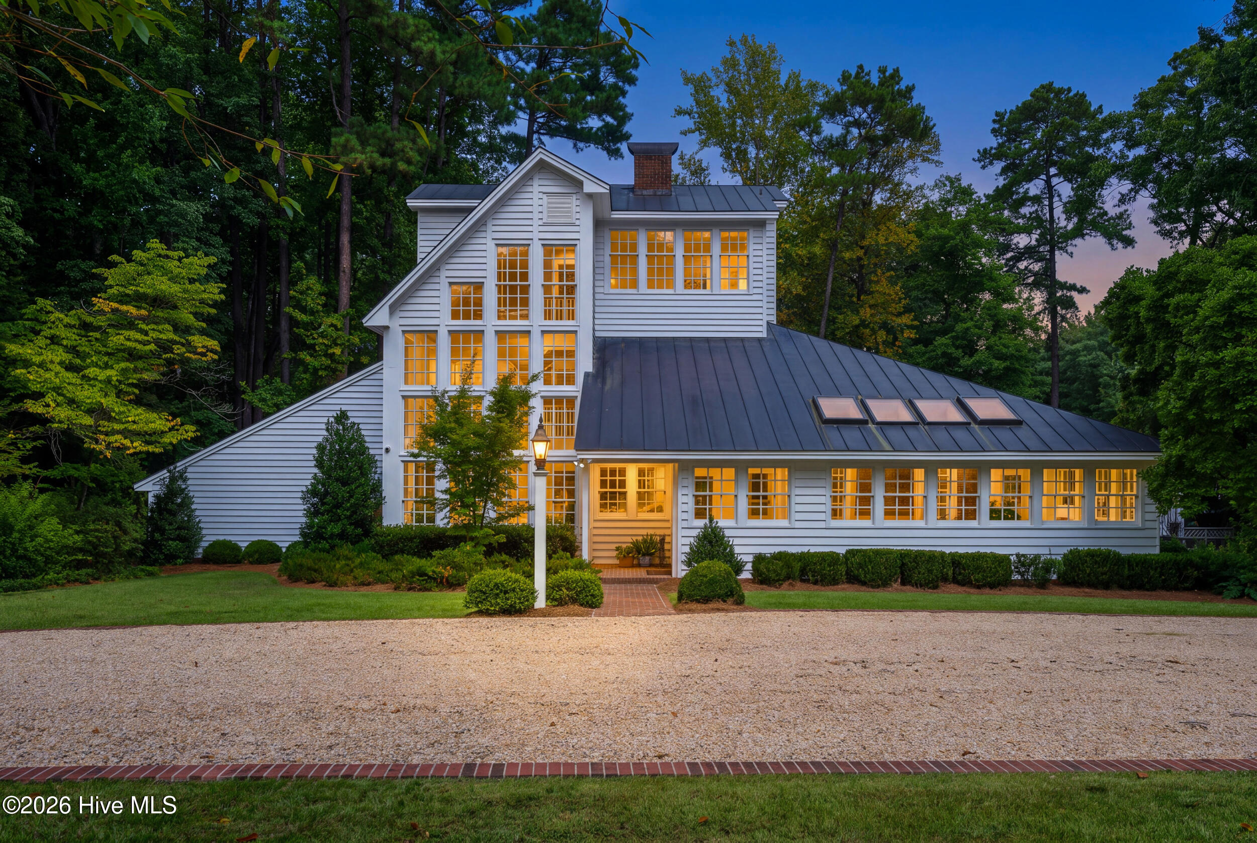 Welcome to this stunning three-story custom-designed home in the heart of the desirable Candlewood neighborhood.  Featured in the September 1985 edition of Southern Living Magazine, this 4-bedroom three-bathroom home has a three-story sunroom with a passive solar design, floating staircase, exceptional outdoor living spaces, and resort-style saltwater pool.  This one-of-a-kind home truly has it all.  Designed to take advantage of an impressive wall of windows, the home welcomes abundant natural sunlight to provide warmth and year-round comfort. From the moment you enter, you'll appreciate the thoughtful craftsmanship, custom details, beautiful lighting, exposed brick accents, pine floors, and distinctive architectural elements.  The welcoming foyer flows perfectly into multiple gathering spaces and an open kitchen and great-room combination. The beautifully appointed kitchen features a high-end gas range, while the granite wet bar in the enclosed sunroom creates the perfect spot to enjoy a refreshing beverage while taking in the natural light.  The first-floor primary suite offers privacy and convenience, with a beautiful private bath.  Step outside to multiple covered and screened-in decks overlooking the beautifully landscaped backyard and saltwater pool.  The private screened-in porches provide exceptional spaces for entertaining, relaxing, and enjoying the outdoors.  On the second floor you will find bedrooms 2 and 3, along with a spacious bonus/flex space, perfect for an office or workout space.  On the third floor, is another primary suite perfect for relaxation, privacy, and natural light.  The third-floor balcony overlooks the dramatic three-story interior space, creating an unforgettable view and a truly special retreat.  Additional features include, large corner lot, attached two-car garage, workshop/gardener's area, storage shed, copper roof, and tankless hot-water heater.