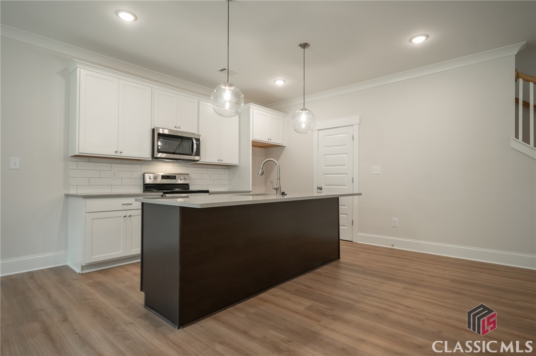 Stylish New Construction, Multi-family zoned, 4/3 home with open floor plan, 2 porches, attached 2 car garage on .63 acre lot, approximately 2 miles from Downtown Athens, UGA campuses, Piedmont hospital, near Sandy Creek Nature Center, Holland Park Sports Complex, and is within the Chase Street, or recently renamed, Johnnie Lay Burks elementary district. Also, Jittery Joes coffee is within a block, and Terrapin brewery is 2 blocks away, so 2 staples of a good life are walkable destinations! This is an area that is fast evolving as an extension of Intown, remarkably convenient to everything that makes Athens a highly desirable place to live. This is one of 4 recently completed homes on this block, each move-in ready. Additionally, with RM zoning, these homes could be used as Airb&b/VRBO sites.