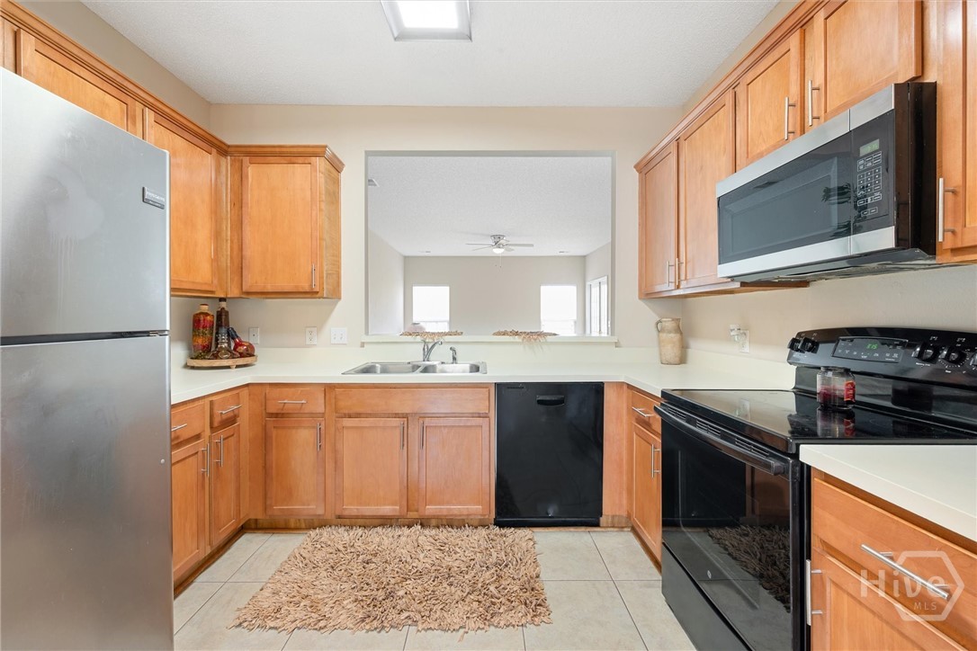 Abundant cabinetry and black appliances.