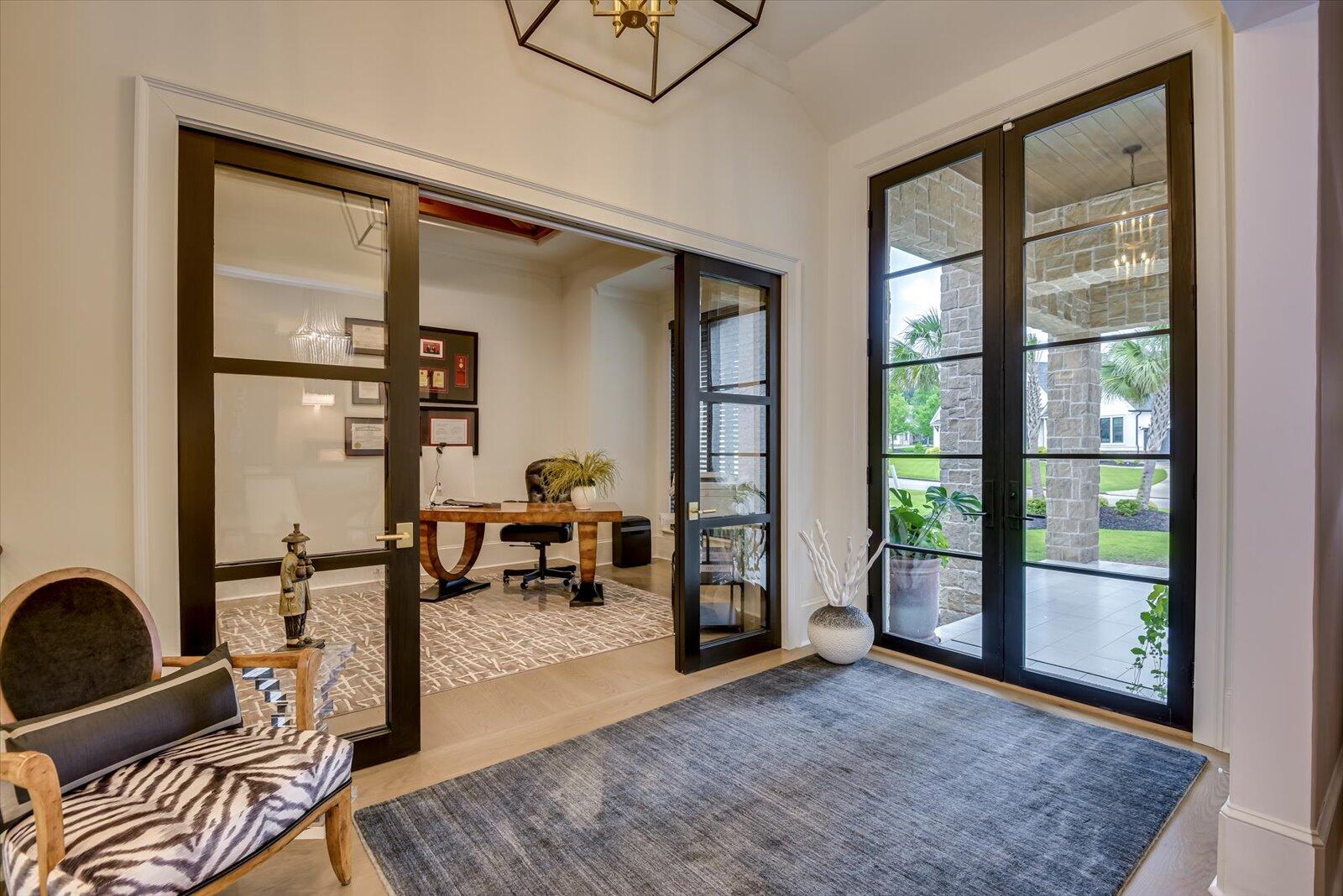Office with custom built cabinets, Colorado cedar beams in the trey ceiling. Glass wood sliding door.