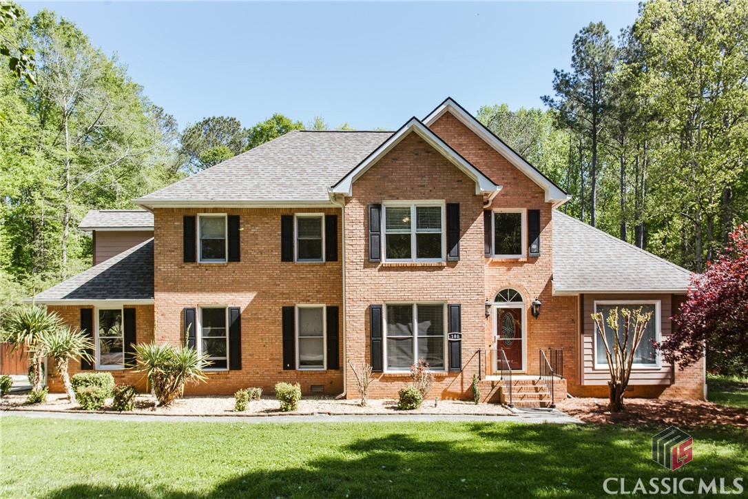 This stunning traditional brick home boasts 4 bedrooms and 3.5 bathrooms, perfect for a growing family or an owner that enjoys hosting guests, either indoors or out.  A truly timeless entry, you walk into a welcoming vaulted foyer flanked on either side by a beautiful and spacious dining room (complete with shadow box wainscoting) and a large home office or formal living area.   Both of which offer ample room for creativity in hosting or productivity and wonderful natural light.  The beautiful and updated kitchen features granite countertops, white cabinets, a stylish subway-tile backsplash, stainless appliances (double wall ovens) and a comfortable eat-in area.  Off the kitchen is a large laundry room and access to the two car garage.  Across the large living room, complete with vaulted ceilings and mantled fireplace, you’ll find a half bathroom perfectly suitable for guests.  The primary suite is on the main floor and offers a spacious ensuite bathroom with double vanities, garden tub and tiled, frameless glass shower, and walk-in closet.  Up the stairs, you will find three bedrooms, all of which have large closet space and storage areas and easy access to full bathrooms. Two of the rooms feature access to the central jack-and-jill bathroom.  Off of one of the bedrooms, you’ll find a study nook with walled cabinetry for storage.  Perfect for the crafter, the collector, or the most studious of occupants.  And don't forget the additional bonus room just across the catwalk — lit up by skylights during the daytime and offering a flexible and unique bonus space for hanging out (with a projector screen for movie nights with family and friends!) The real gem of this home is the amazing backyard where you can escape to your own private oasis after a long day.  The yard is level, large, and fenced in, making it the perfect spot for outdoor activities on the lawn or to let the pets roam with plenty of space.  You’ll spend many sunny days sitting by the above ground swimming pool, grilling on the large deck or lounging under the covered porch watching the sunset with a cool breeze from a fan. Want to enjoy your 1.24 acres any way you please - no HOA in the neighborhood! You can enjoy the convenience of nearby shopping and restaurants without any pesky fees or regulations.  Enjoy the convenience of the Eastside of Athens, just minutes from shopping, restaurants and UGA’s vet school. So what are you waiting for? Come see this home today and fall in love with your new oasis.