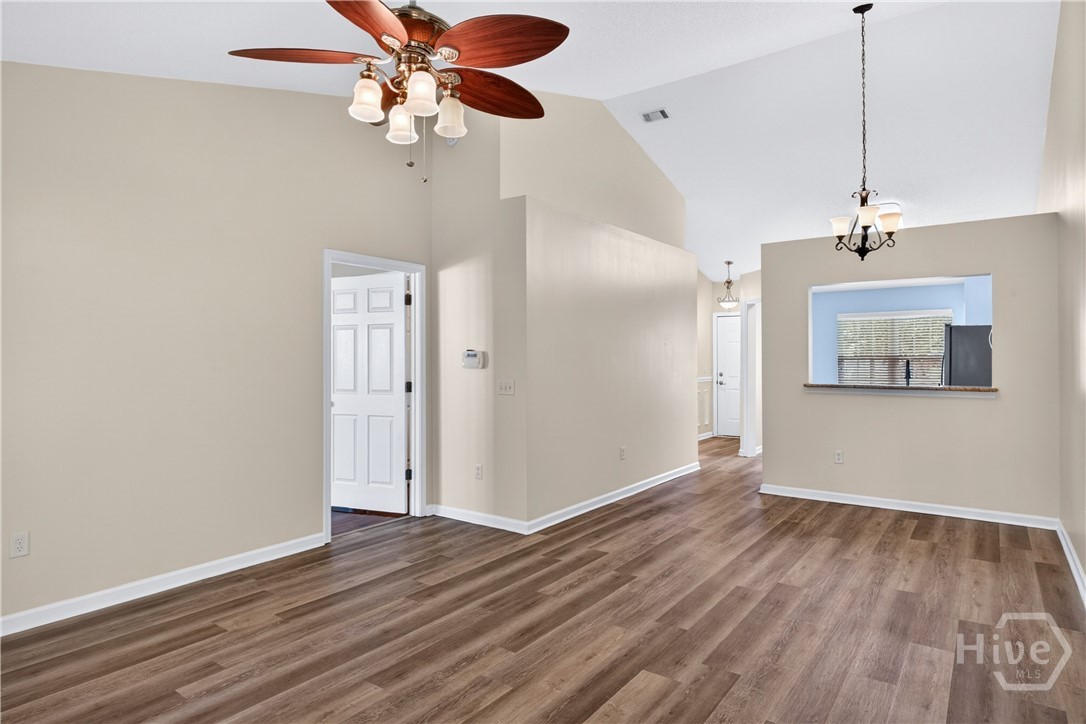 In the living room looking back to the kitchen pass through window, entrance hall and master bedroom entry door