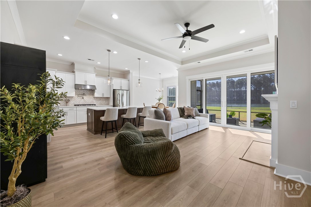 Open concept living space connecting the great room, kitchen, and dining area