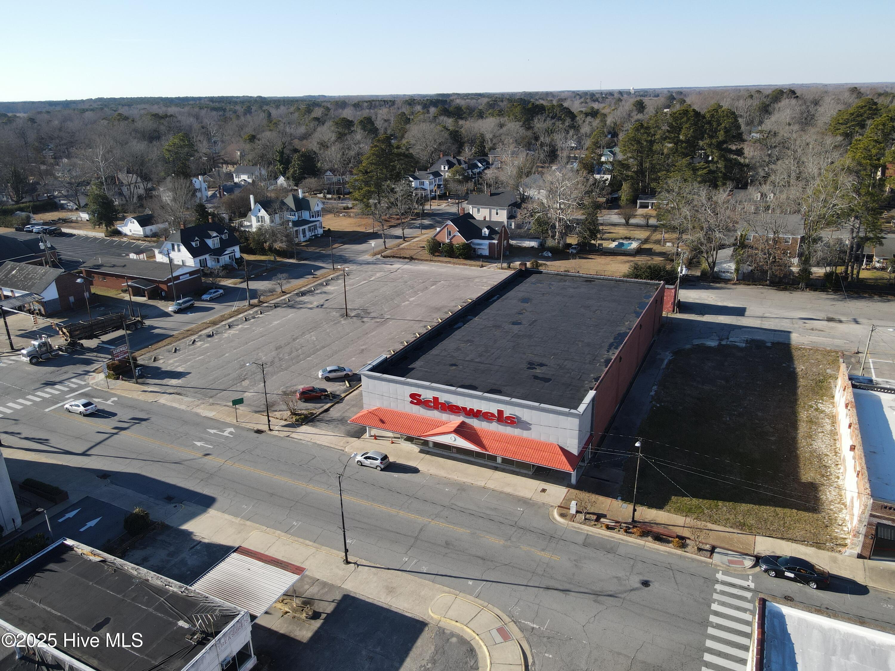 Seize this unique opportunity to own the largest storefront property in the heart of downtown Williamston, North Carolina! Ideally situated just 1.5 hours from the Crystal Coast and Raleigh Airport, this prime location offers the perfect balance of accessibility and charm. Whether you're launching a new venture or growing an established business, this spacious property provides the ideal canvas to bring your vision to life, with a central East Coast location to support your success.
Boasting over 17,000 square feet, this is the largest building downtown, featuring an open window front showroom perfect for showcasing your business. The property also includes a detached 1,000+ square-foot warehouse (unheated) and a spacious parking lot with over 80 spaces—ideal for accommodating customers and staff alike. 
This is your chance to make a meaningful impact on a vibrant small-town community that's brimming with potential. Seize the opportunity today!