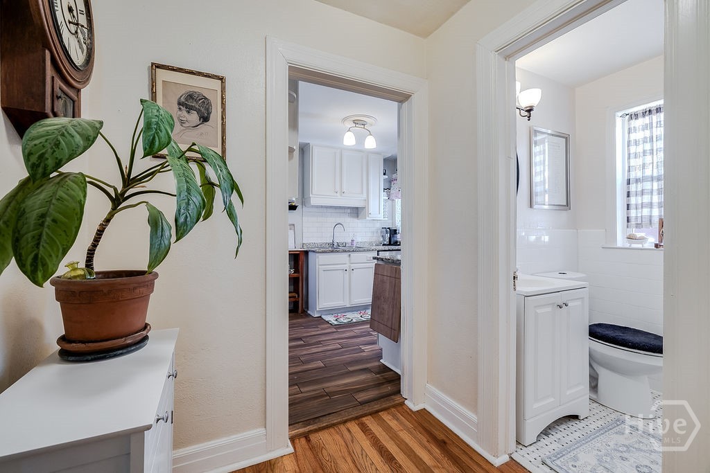 hallway leading into kitchen and 2nd full bath off to the right.
