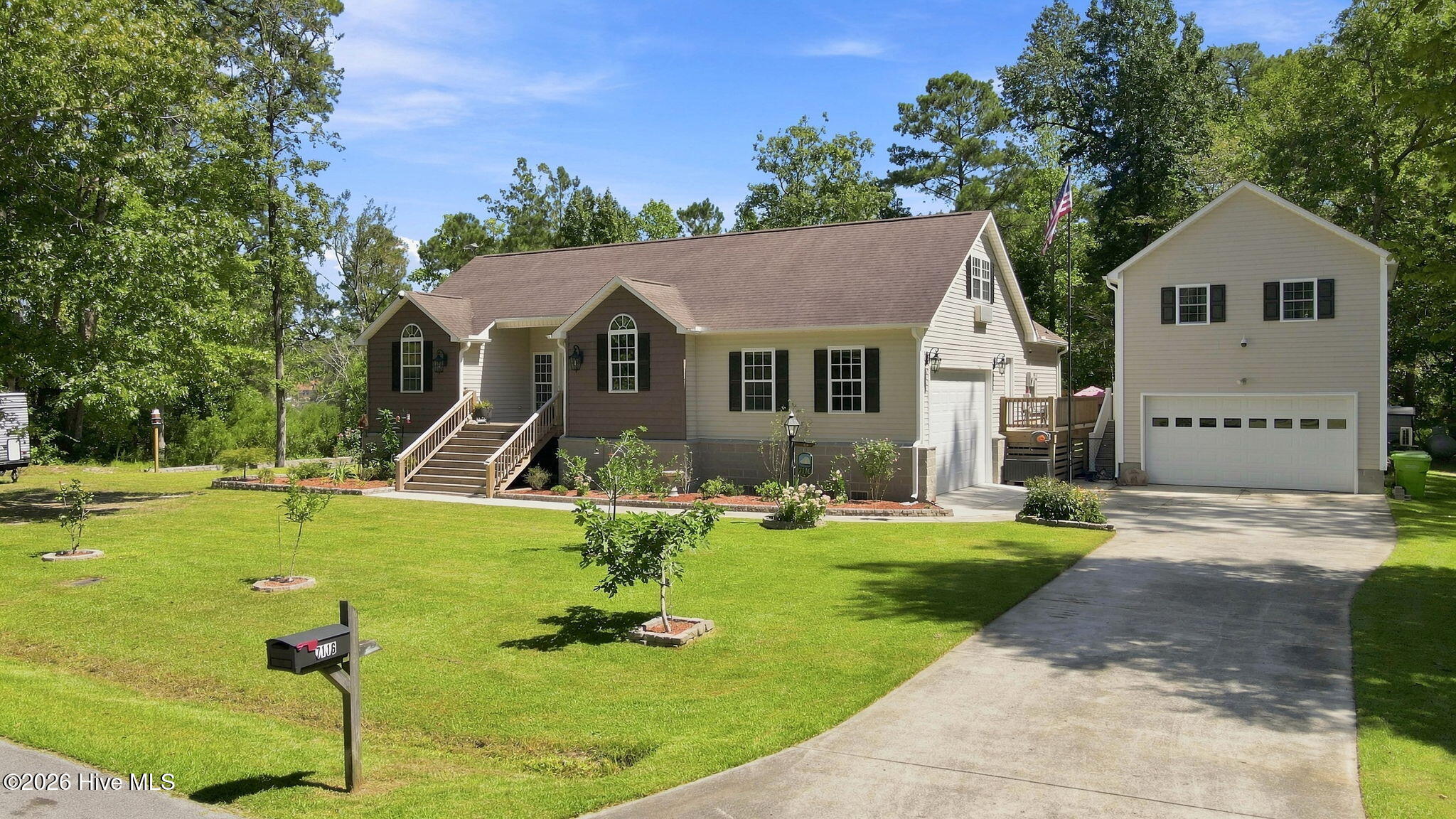 An exquisitely remodeled and improved residence on a lovely lot near the Village of Oriental! Although originally built in 1998 (the detached garage/studio ca. 2014), you'll be amazed at all of the thoughtful refinements and additions made since then by the current owner. It really feels like new! Having been elevated well above flood risk in 2025 and integrated with ''smart home'' technology, you'll be delighted with the combination of traditional, yet flexible design and contemporary aesthetics. As you enter the foyer from the welcoming front porch, you'll know you're someplace special... The new LVP flooring used throughout most of the home harmonizes the different rooms beautifully which is evident the moment you walk into the airy, vaulted living room. It is enhanced by a new electric fireplace, 82'' TV and surround sound system. The room flows and opens into the cozy dining area, three-season porch and the spectacular gourmet kitchen! The kitchen is a dream - expansive granite counters, new upper cabinetry, state-of-the-art appliances and even a R.O. water pot filler at the stove! The bedroom arrangement features a master suite w/new electric fireplace and lovely bathroom. The guest wing is on the other side of the home, each of the 2 bedrooms having a special feature - one is vaulted, the other has dedicated access to the 12'6'' x 22'6'' sundeck! A finished room above the garage would make a perfect office. The attached garage has its own mini-split heat pump, as does the detached garage/workshop!! The workshop is perfection for the craftsman - storage, sink w/instant hot water and garage doors on both sides... The studio suite above is also served by mini-split and features a full bath and kitchenette area. A more flexible design is hard to envision. The very private backyard is fully fenced for pets and kids and even has a protected garden area ! So many quality features - standby generator, Alexa-ready smart technology features, new decks, patio and more! Excellent curb appeal with wide, gracious front steps and a lovely combination of exterior finishes. A friendly neighborhood also awaits, walking distance to all the coastal charm of Oriental and your dream residence is ready to welcome you home!