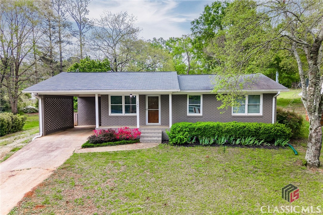 Adorable, affordable, and updated home in Downtown Commerce! Hardwood flooring runs through the living room and bedrooms. The hall bathroom has been updated with new tile floors, new vanity, and new subway tile tub surround. Eat-in kitchen features stainless steel appliances and is adjacent to the laundry room. New electrical panel, vapor barrier, and sump pump. The backyard is huge and perfect for pets or a vegetable garden. Wired storage shed with roll up door would make a great workshop with minimal modifications. Located down the street within a walk, scoot or roll from the city recreation complex & Veterans Park which features a community pond, walking trails, playground, tennis courts, ball fields, and pool! Minutes away from downtown Commerce shopping & dining, schools, I-85 and 441.