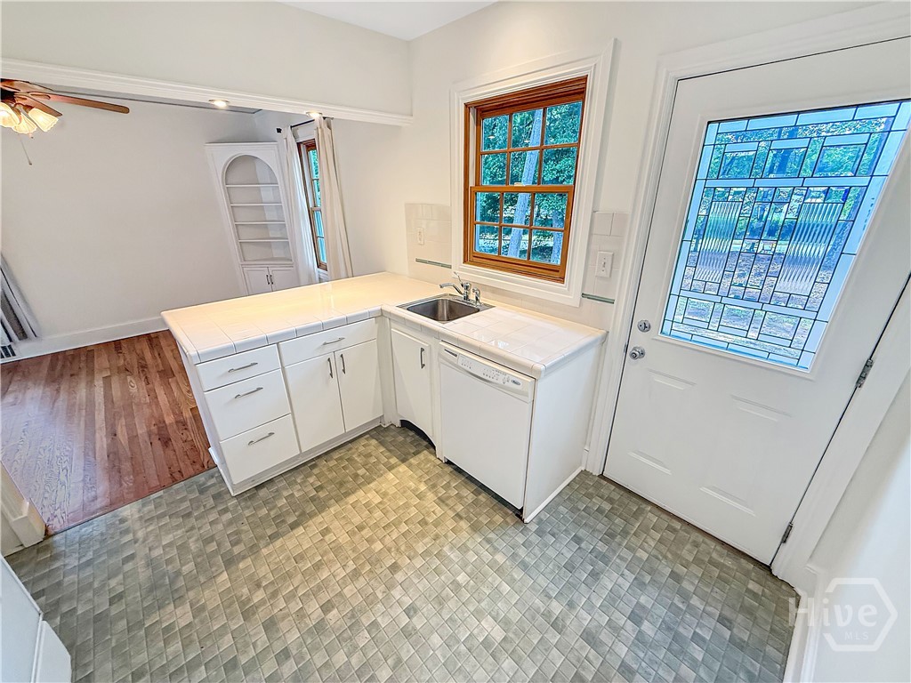 Kitchen w/ a door to the Backyard