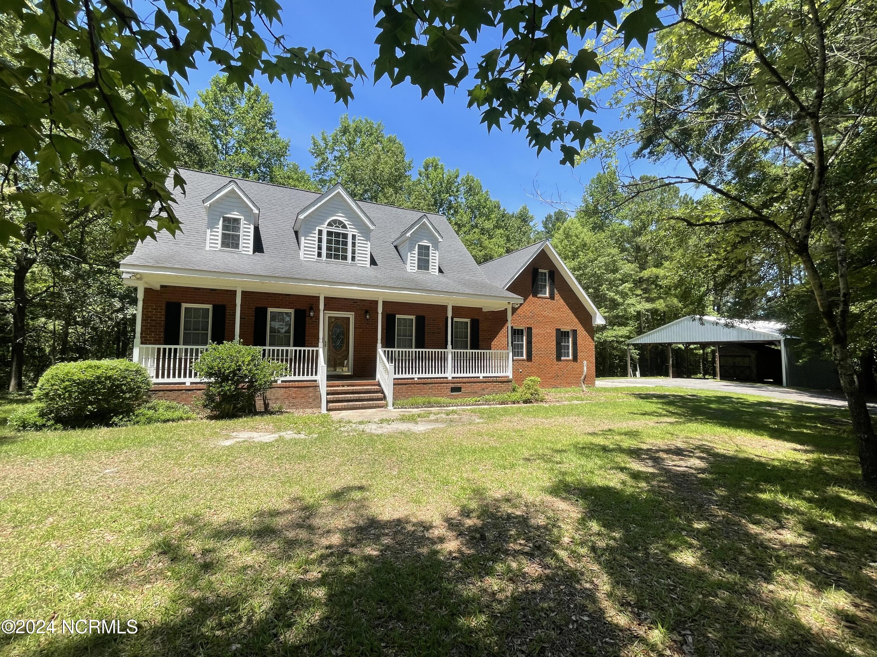Your dream home has arrived! This stunning 3-bedroom, 2.5-bathroom country charmer is now available. Entertain family and friends in the spacious living room and formal dining areas, or sip your morning coffee quietly on the covered front porch while starting your day. The living room boasts a custom marble fireplace with an oakwood mantle, while the dining and kitchen areas offer picturesque views of wildlife through the windows. These spaces flow seamlessly onto an attached covered back deck, perfect for summertime cookouts. The master bedroom, located downstairs, features a private bathroom and a large walk-in closet. Upstairs, you'll find two additional bedrooms with a shared full bathroom, plus an extra bonus room. An attached garage provides convenience for unloading items from your car. And there's more—a HUGE detached shelter for your recreational vehicles! Located in the heart of the Farmlife community and just 1.5 hours from the crystal coast, this jewel won't last long. Come see it before it's gone!