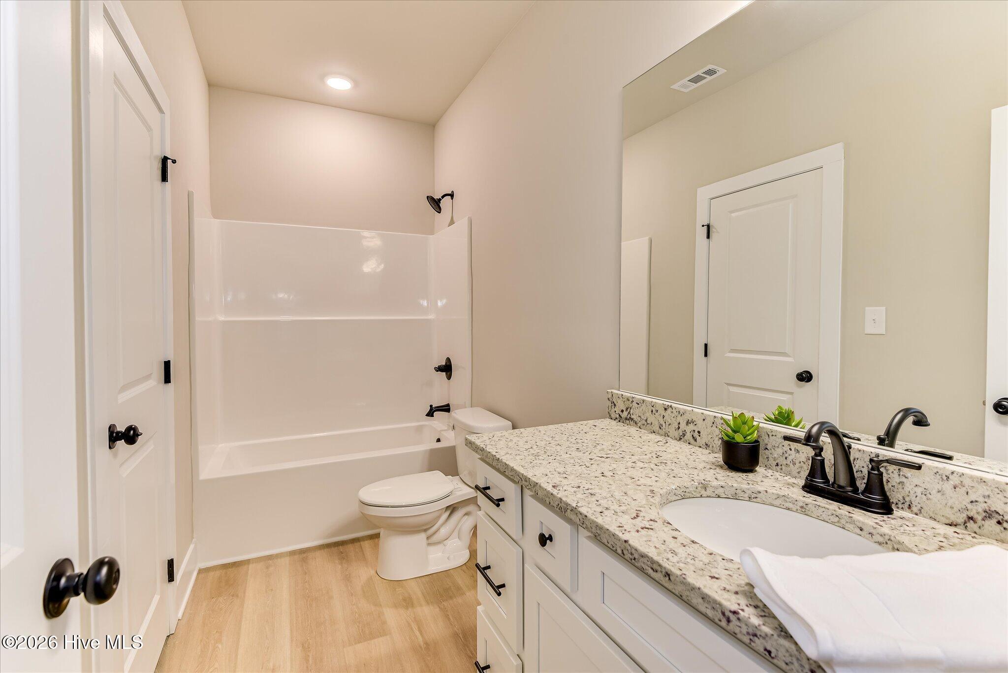 Large, full bathroom with granite countertop and tub/shower combo is downstairs for guests.