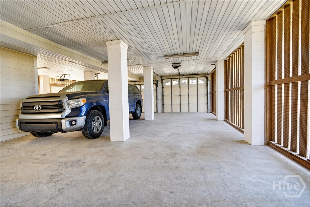 Three car garage that features one door large enough to fit a boat or RV.