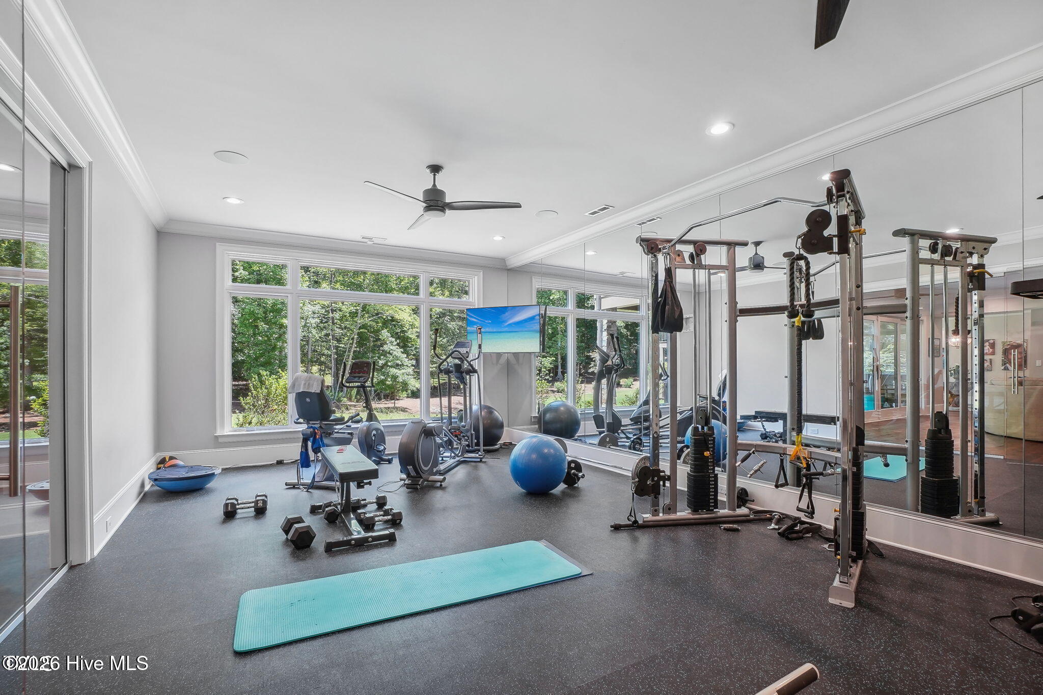 Exercise room with glass paneled entry wall and mirrored interior walls exercise equipment available
