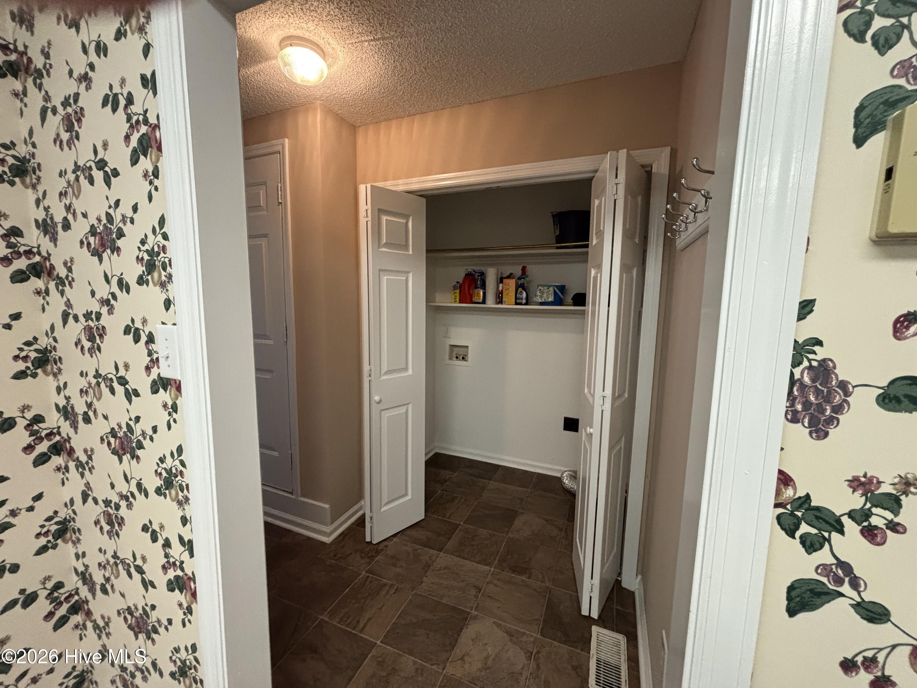 Landry closet off kitchen toward the garage