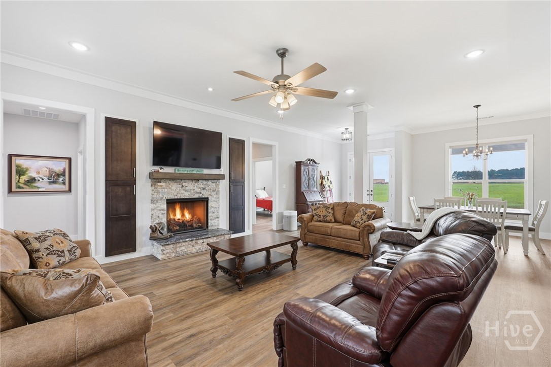 Adjacent large living area with gas log fireplace.