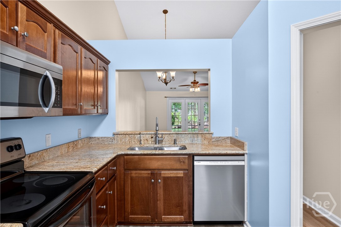In the kitchen with the refrigerator on your left and window to your back - looking thru the pass through to the dining area/living room