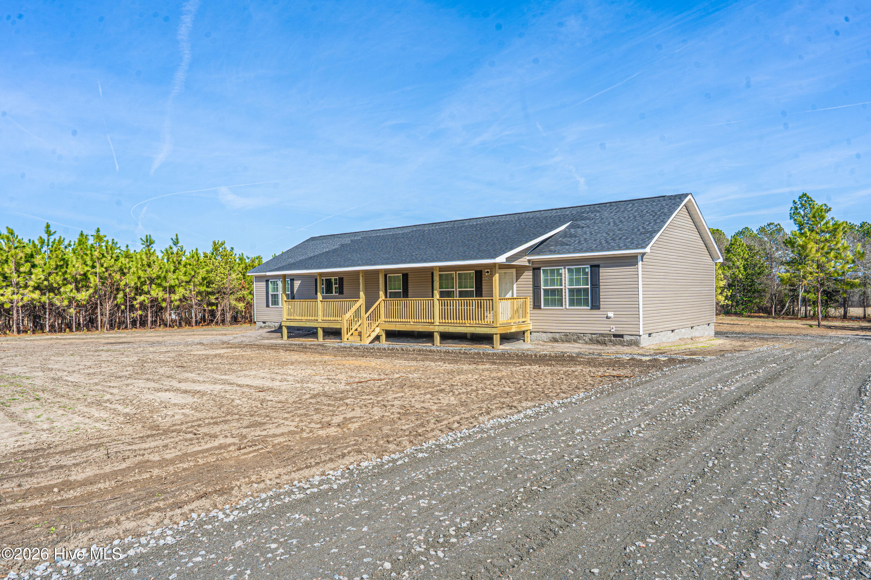 Welcome home to peaceful country living at its finest. This stunning new construction modular home sits on approximately three beautiful acres and offers the perfect blend of modern comfort, space, and timeless charm.Step inside to discover a thoughtfully designed floor plan featuring four spacious bedrooms, three baths, and two inviting living areas -- ideal for both relaxing evenings and entertaining guests. The heart of the home is the large open kitchen, complete with a center island, built-in oven, abundant cabinetry, and generous workspace -- a dream setting for cooking, gathering, and making memories. Natural light fills the home, showcasing the scenic views and highlighting the fresh finishes and modern touches that only new construction can provide. Each bedroom offers comfort and privacy, while the flexible layout allows room for family, guests, or a home office. Outside, the setting is just as impressive. Mature, towering pine trees surround the property, creating beauty, shade, and a sense of peaceful privacy. The charming front porch is perfect for rocking chairs, morning coffee, or sunset conversations, while the spacious back porch is ready for outdoor dining, entertaining, or simply enjoying the quiet country surroundings.If you've been dreaming of a brand-new home with room to breathe, space to grow, and a setting that feels like a retreat every day, this property delivers it all.