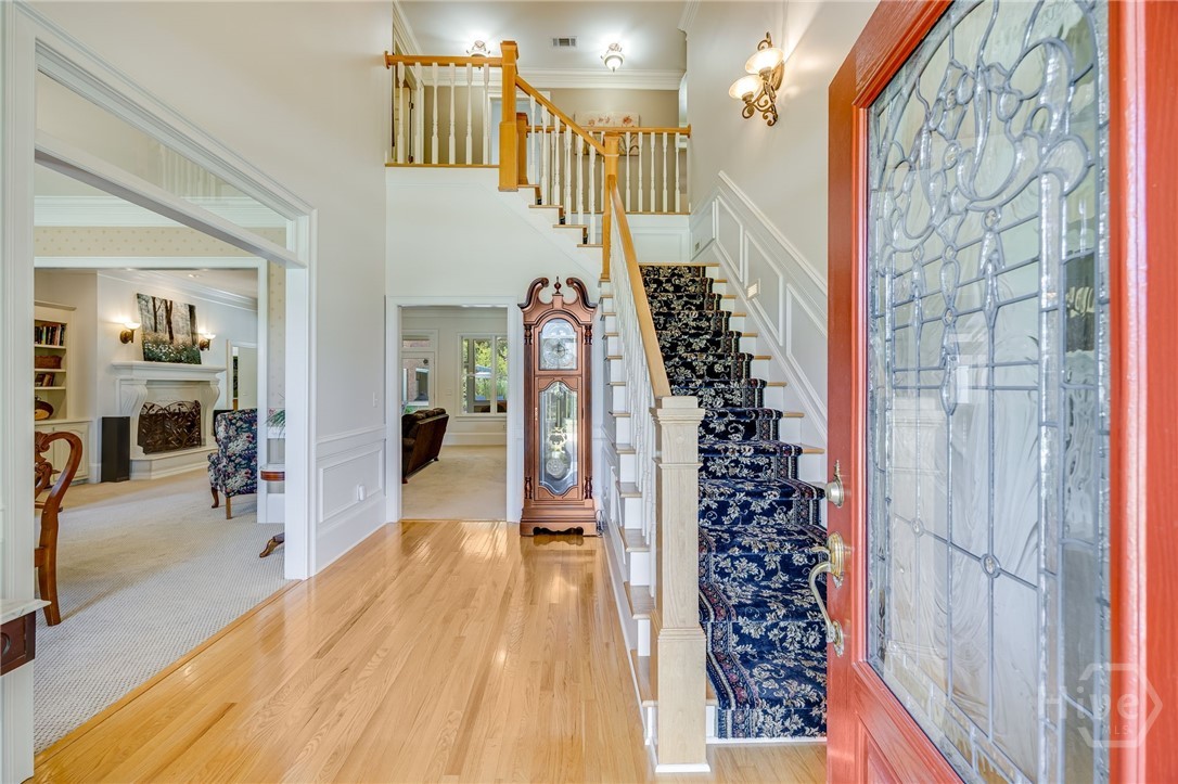 Leaded glass door with gleaming hardwoods in entry
