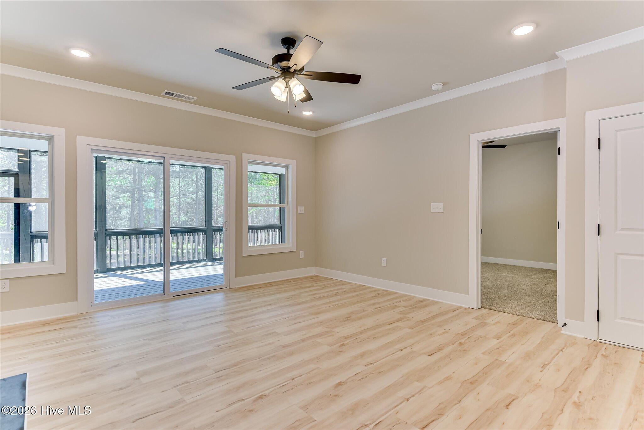 Sliding doors to rear screened porch, door to Primary bedroom