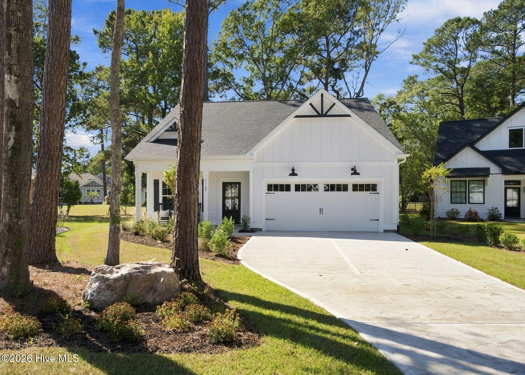 JUST COMPLETED and ready for you to call it home!! This stunning new construction home is 3 bedrooms, 2.5 bathrooms, and approx. 1,611 heated sqft of the perfect blend of craftsman & coastal selections located in Brick Landing Plantation. As you step through the front door into the living room, you'll notice custom trim on the walls, staircase to your right, and a half bath before leading into the kitchen. Standard kitchen features in this home include custom cabinetry with soft close hardware, quartz countertops with an overhang on the island to accommodate room for extra seating, and stainless steel appliances (included: stove/oven, refrigerator, microwave, dishwasher). The kitchen has a side door that allows access to the rear yard, perfect for entertaining! In the bright & airy primary suite you'll find the following features: walk-in closet with custom wooden shelving, dual vanity in the bathroom, glass shower door, and shower with tile walls. Upstairs, you'll find two guest bedrooms and the guest bathroom. To top it all off, exterior features include custom gable brackets, professional landscaping, and durable fiber cement siding. Brick Landing Plantation is a lovely GATED community with amenities that include a community outdoor pool, tennis/pickleball courts, basketball court, and security guard. Enjoy all that coastal living has to offer; Ocean Isle Beach is less than 5 miles away and the nearest public boat ramp is less than 1.5 miles!! Links at Brick Landing golf membership is separate from BLPMA dues.  Furniture is property of staging company and does not convey.