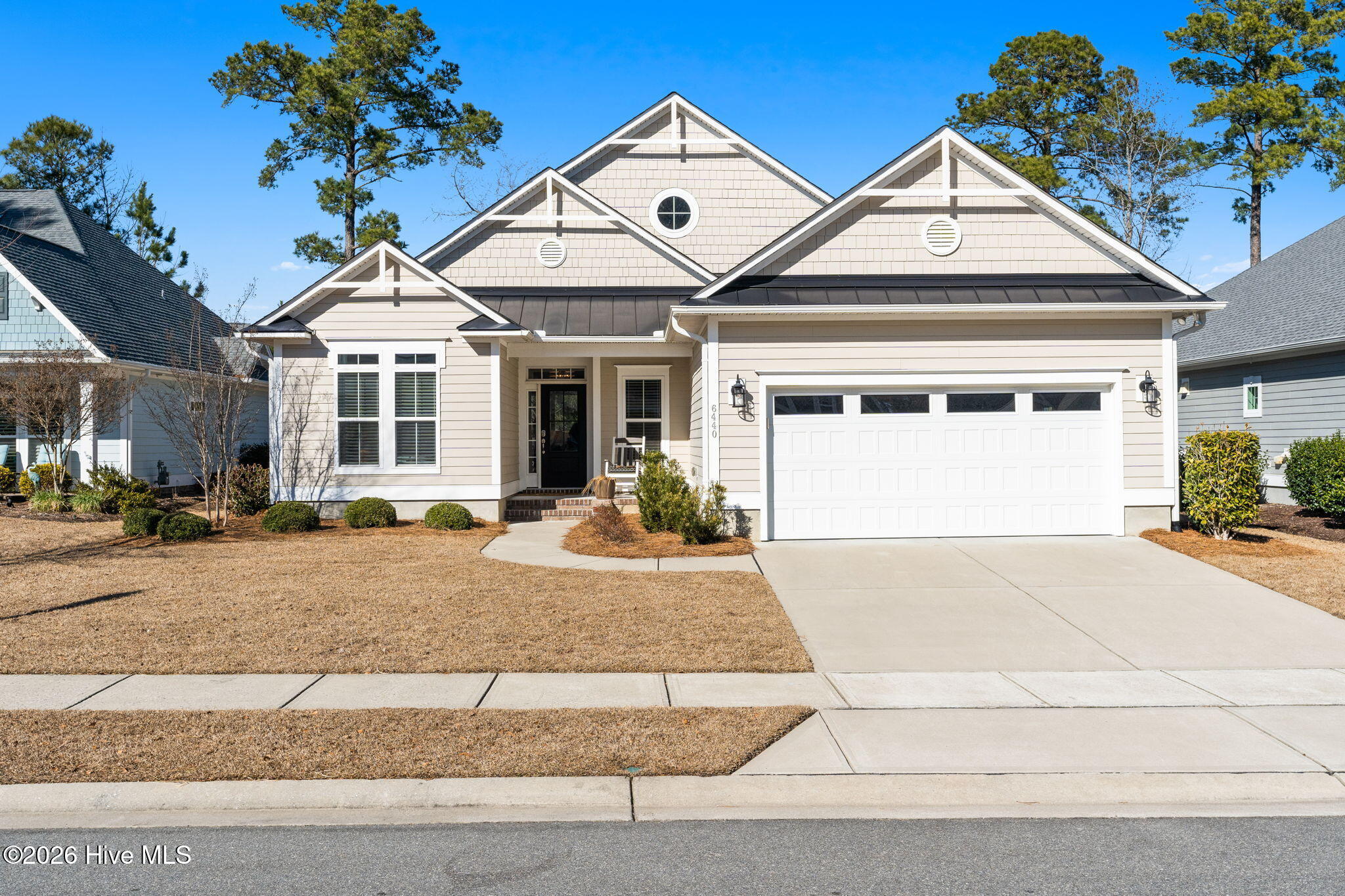 Welcome to The Bayshore by Logan Homes.  Located in the highly desirable Shelmore neighborhood of the amenity-rich Brunswick Forest Community, this exceptional and beautifully maintained home sits on a 0.20-acre lot. Built in 2021 as a model home, it remains in like-new condition, offering impressive features and recent upgrades throughout. In 2024, the entire interior was freshly repainted, giving the home a modern and revitalized appearance. New ceiling fans have been installed in every room, and recessed lighting was added in the living room, dining area, master bedroom, and office, enhancing both ambiance and comfort. The main level's carpeting was replaced with beautiful hardwood flooring, bringing warmth and elegance to the living spaces. The home features three spacious bedrooms and three full bathrooms. The first-floor primary master suite includes a walk-in closet with extensive shelving for ample storage. A dedicated study or office, offering a private workspace ideal for working from home.  An open floor plan seamlessly integrates the formal dining room, distinguished by a bright accent wall, with the living room, which is enhanced by a gas fireplace for warmth and a cozy ambiance. The kitchen is both stylish and functional, featuring an impressive 8-foot quartz-topped island, soft-closing drawers, and a gas stove—perfect for any home chef. Upstairs, a large bedroom with a private ensuite bathroom provides an ideal private space for guests. From the main living space, telescope sliding doors open to a covered, screened-in porch, creating a versatile area perfect for entertaining. This design allows for effortless indoor-outdoor living while offering protection from the elements. The home backs up to a wooded area, providing natural separation and privacy from nearby neighbors. The spacious two-car garage is equipped with epoxy floors, a storage closet, and a pull-down ladder leading to a large, floored attic—ideal for storage and organizing belongings.