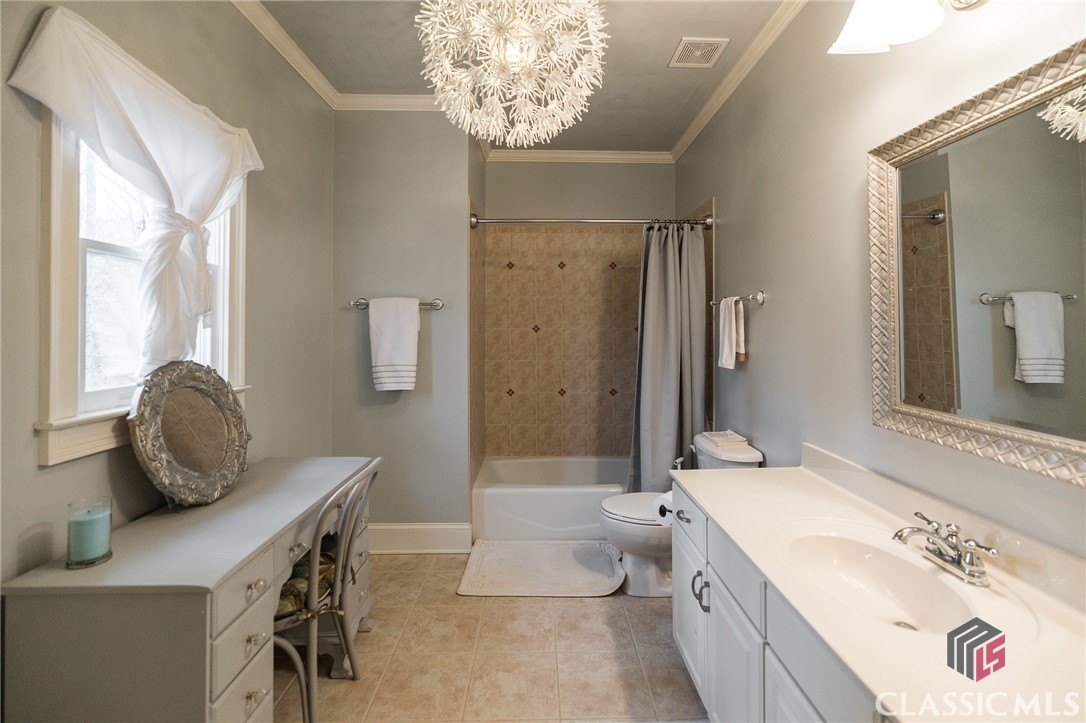 Welcome home to 1095 Westminster Terrace. Rowan Oak is a distinguished, gated community and is located in the award winning North Oconee school district. Rowan Oak is the perfect location to get to Downtown Athens and UGA  or to hop on 316 for a commute to Atlanta. A gorgeous iron gate greets you at the entrance and provides an extra level of security for all residents.  Loved and cared for, Westminster Terrace is an outstanding brick and stone beauty that has it all! This home has been gently lived in and is perfectly nestled on a private wooded lot overlooking a wide, bustling creek.  The privacy of this lot is a HUGE selling point, and the remarkable views and sounds of nature will captivate you! You can also enjoy the upscale, central amenities including a clubhouse, pool, tennis, walking trails and playground. A superior floor plan, the owner's suite is conveniently located on the main level with window seating, tray ceilings and access to the screened in porch with outdoor fireplace. The fully remodeled master bath offers a stunning frameless glass shower, beautiful double vanity with white quartz countertops, separate lavatory and walk in closet. Another outstanding feature is the second bedroom located on the main level with its own full bath. The two story foyer opens into the great room which has a travertine surround fireplace with gas logs and built in shelving flanking both sides. A well appointed wet bar is hidden behind one of the cabinets with a small sink, tile backsplash and wine glass storage. Conveniently located to the right of the wet bar is a built in wine cooler. The formal Dining Room is accented by the heavy crown molding that you would expect in a home of this nature. The HEART of the home is the newly renovated kitchen with a large island and eat in kitchen area that opens into a gorgeous keeping room with access to both a screened in porch and a separate grilling deck. You can enjoy your morning coffee while viewing the beautiful creek in the vaulted sitting area! Completing the main level is the laundry/mud room with utility sink and exterior access. The entire main level features newly finished hardwood floors! Upstairs you will find three additional bedrooms and two full bathrooms. One of these bedrooms has an en suite bath, and the other two share a large full bath.  The walk out terrace level has been refinished with a durable stained epoxy flooring that is a functional surface for basement entertaining. With multiple living spaces, you can really have it all! The billiards room features a gas log fireplace and full wet bar with sink, granite countertops, ample cabinetry and a mini fridge! In addition, there is a graciously sized family room, separate office with interior french doors and a full bath! Plenty of additional unfinished storage space is available for all of your storage needs.  With a mature landscape, this private oasis is the perfect setting for the new Spa and spacious stone patio overlooking the creek. Immaculately cared for and move ready!