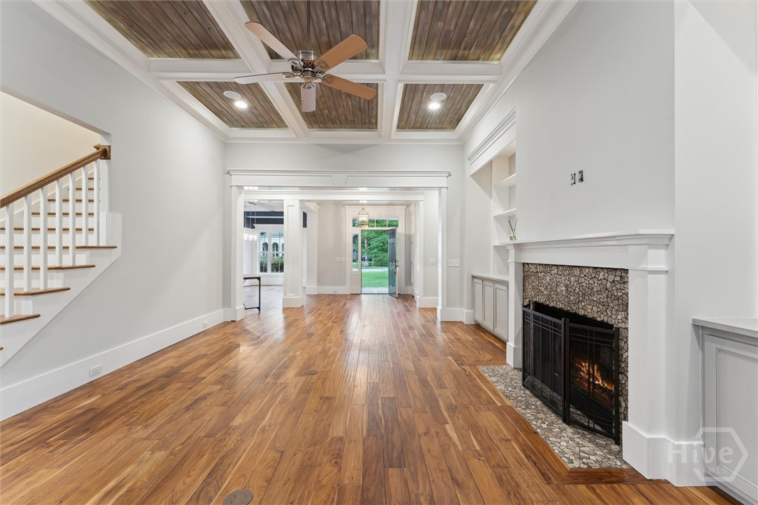 Living room featuring coffered ceilings and firepl