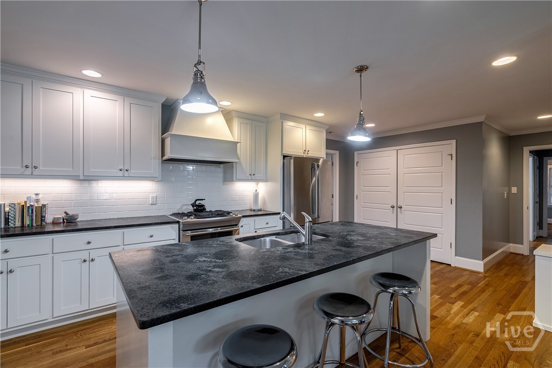Kitchen with white cabinets and granite  counterto