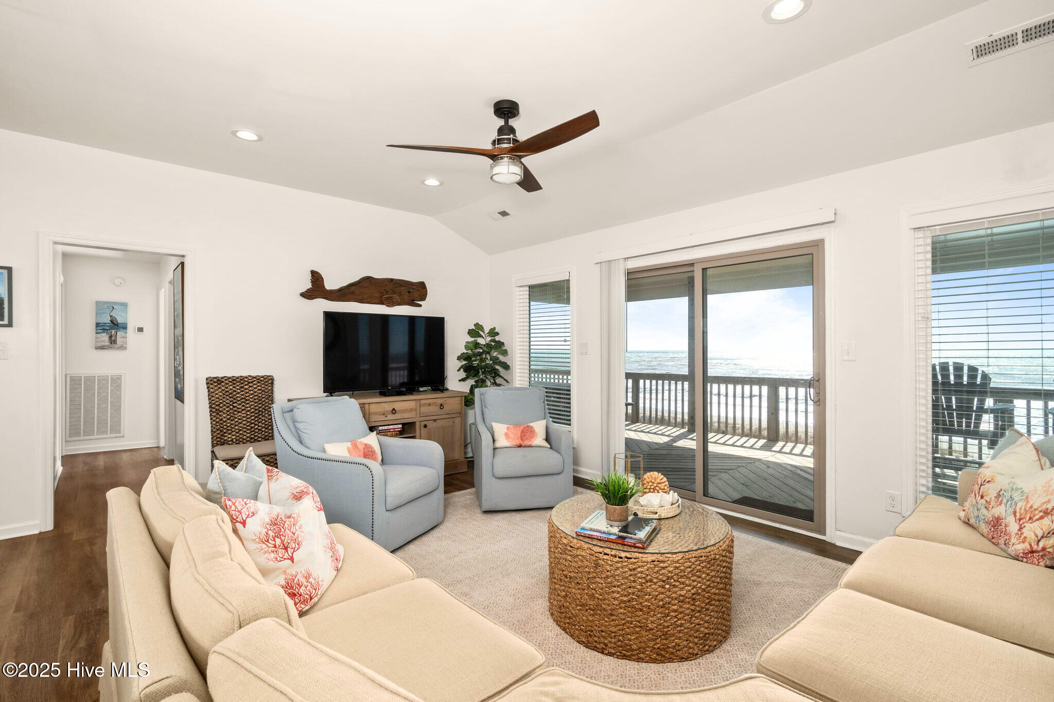 open concept living room opens to deck