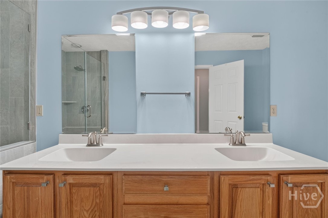 Primary suite bathroom with double vanities