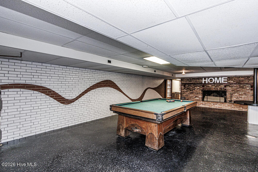 Basement with pool table and fireplace