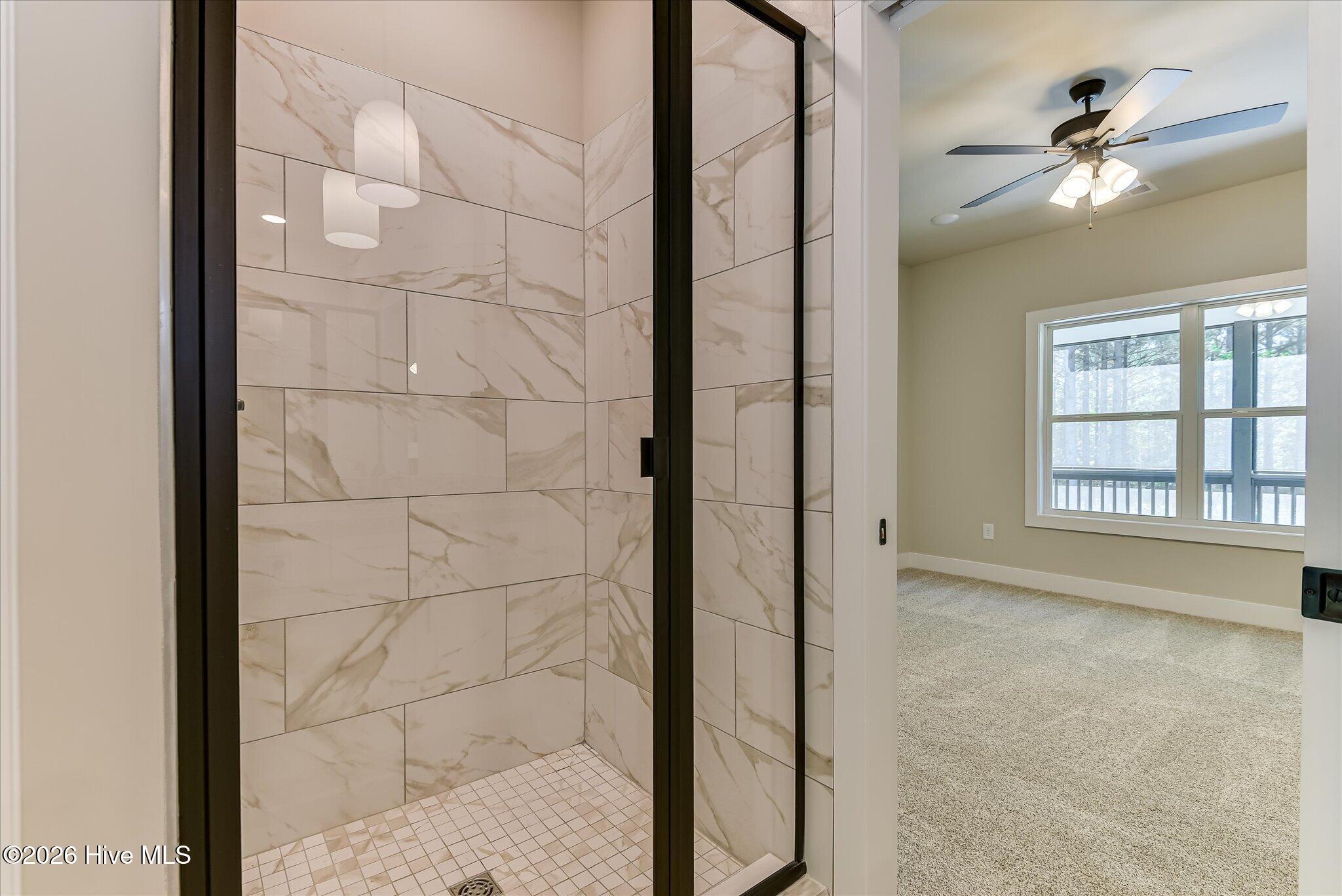 Primary Ensuite with double-sink vanity, tile shower, large walk-in closet
