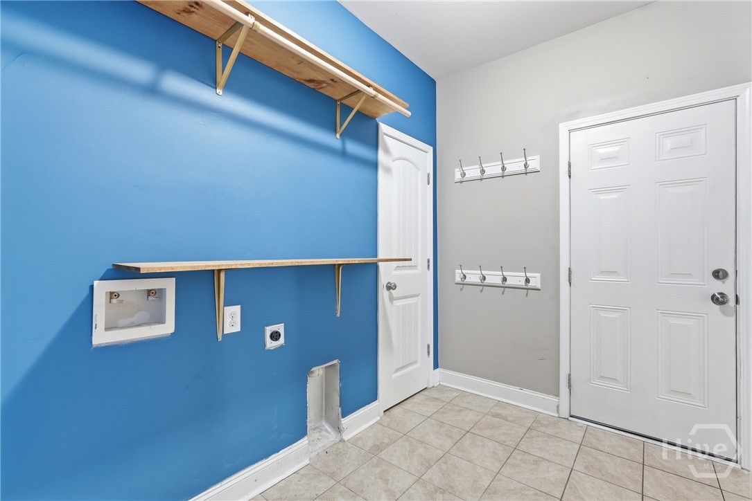 Laundry accessible to gargage and primary closet