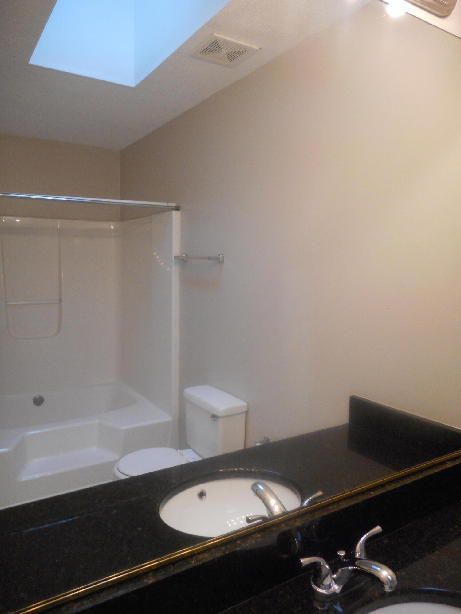 Owner bath with skylight, granite countertops and garden soaking tub.