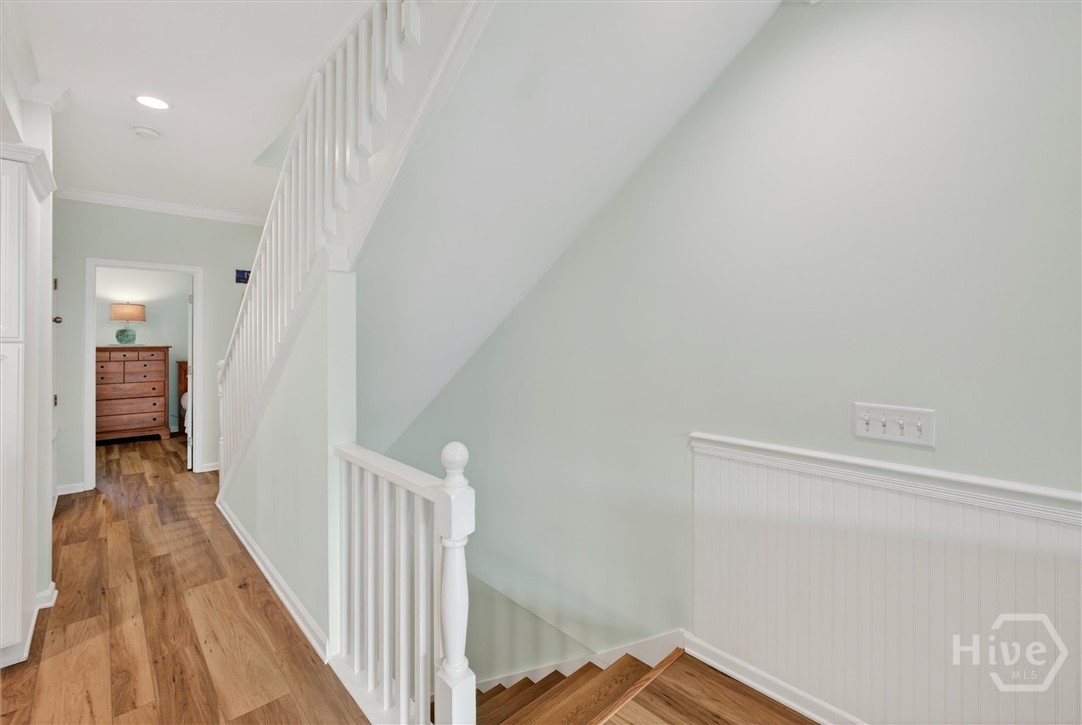 3rd floor hallway with laundry and storage closet on the left and guestroom directly ahead