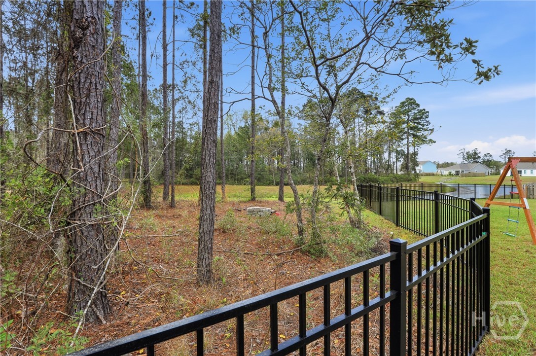 Backyard with fire pit, overlooking pond