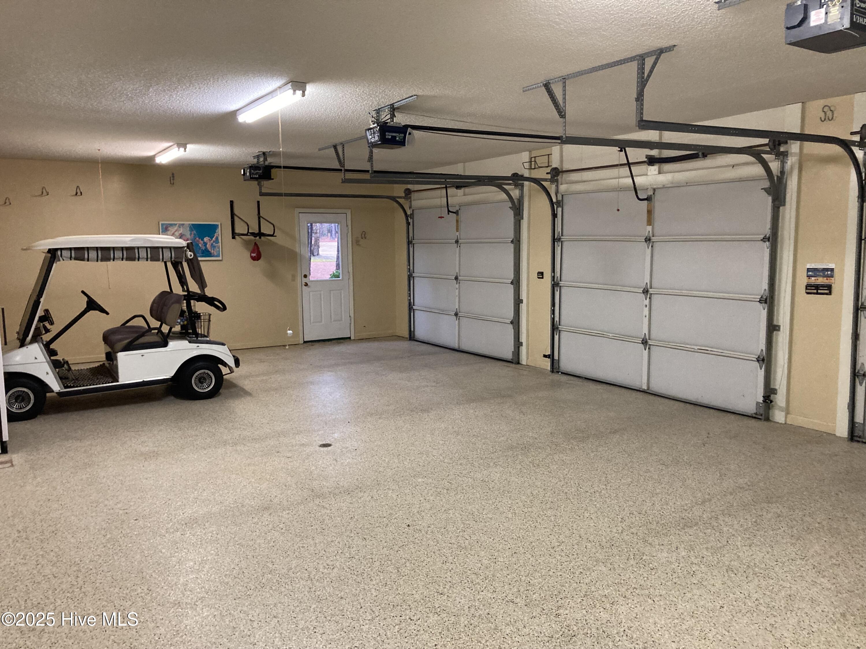 3 car garage, golf cart conveys