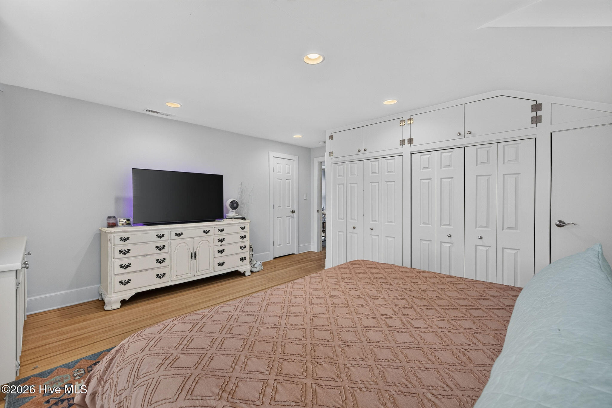Spacious master bedroom suite with built-ins and closets