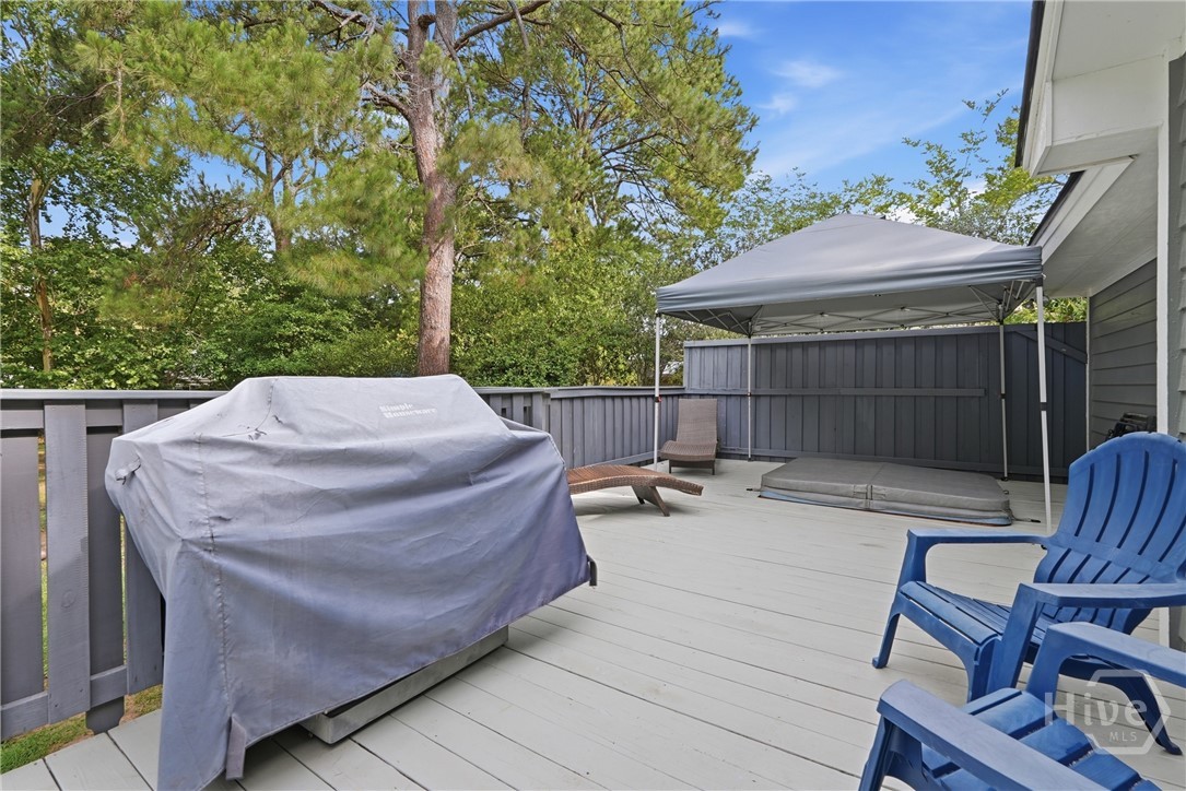 Large outdoor backyard deck features an area for g