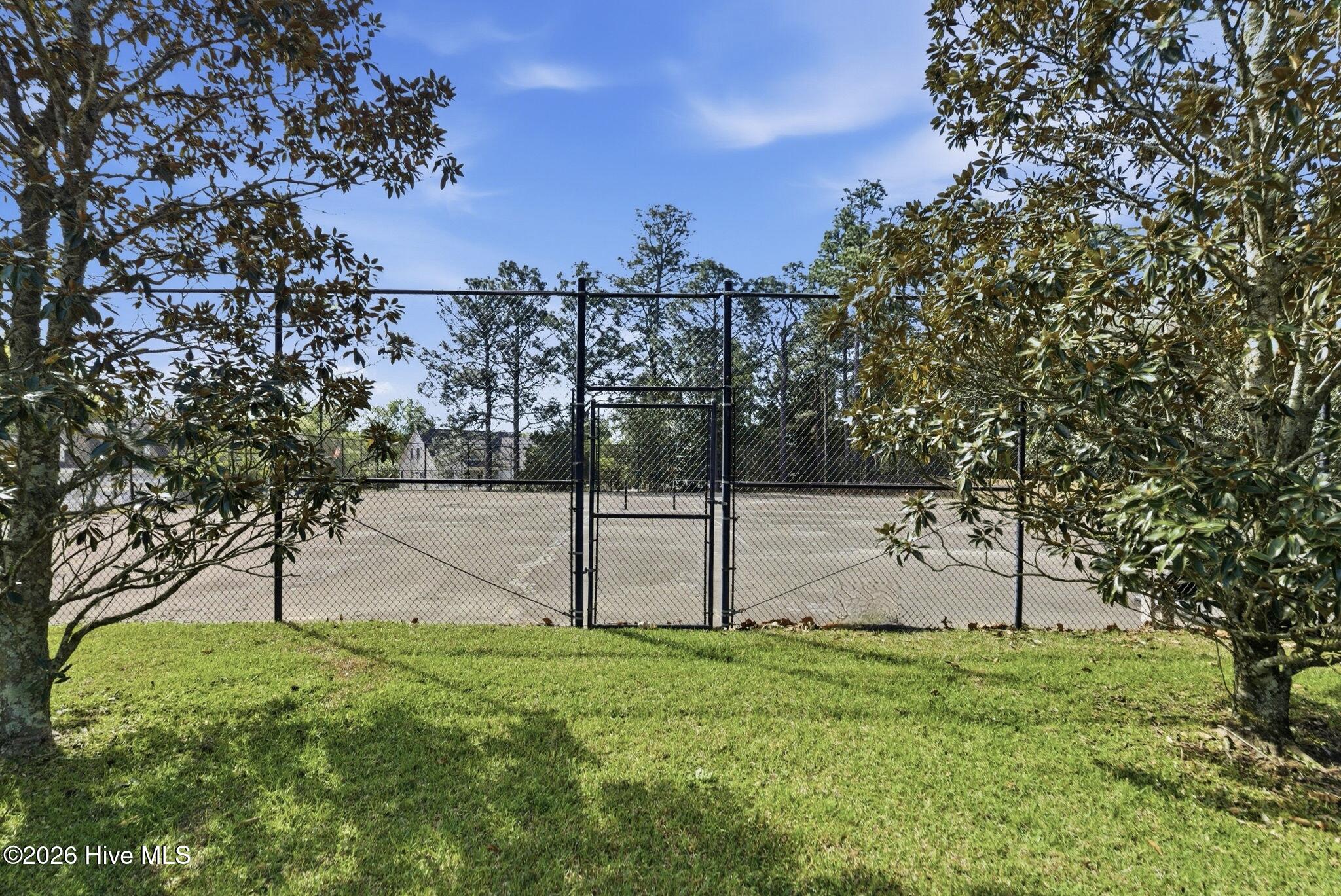 Two regulation tennis courts surrounded by a commercial-grade wire fence and including commercial-grade lighting for night play. Courts need to be resurfaced.