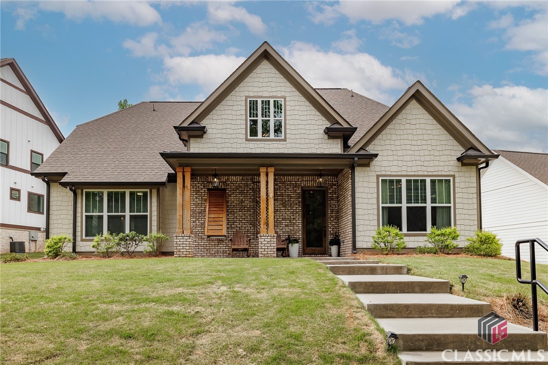 Welcome to refined Southern living in the highly sought-after Oak Grove subdivision. This stunning two-story residence blends luxury, comfort, and thoughtful design at every turn.The main floor boasts soaring ceilings that enhance the sense of space and light, anchored by an inviting great room where natural wood beams frame the ceiling and complement the open shelving flanking a beautifully appointed fireplace. The adjacent kitchen is a chef’s dream, featuring gleaming quartz countertops, custom cabinetry, a gas range with pot filler, walk-in pantry, and ample prep and cooking space—perfect for everyday living and entertaining alike. A cozy breakfast area completes the space, ideal for casual dining with a view. The dining room also showcases high-end designer touches, from textured wallpaper to elegant draperies, all beneath a show-stopping wood-inlaid tray ceiling and statement light fixture.  The screened porch offers an additional living space almost year round and the fireplace makes it super cozy when the weather gets chilly-definitely a perfect spot for cheering on the Bulldogs or the Braves.Even the powder room exudes style and sophistication, making every space feel curated and cohesive.  A laundry room completes the main floor.Retreat to the spacious owner's suite conveniently located on the main level, complete with a spa-like en suite bathroom. The inlaid natural wood tray ceiling makes another appearance on the main floor, adding an elegant focal point to the room. The luxurious bath offers a serene escape, featuring a freestanding soaking tub, large walk-in shower, dual vanities, and designer fixtures.Upstairs, you’ll find three generously sized bedrooms and two baths. One of the bedrooms currently doubles as a playroom.  Every inch of this home has been thoughtfully designed with upscale finishes and timeless style, offering both comfort and wow-factor in equal measure.Don’t miss your chance to own this showpiece in Oak Grove—schedule your private tour today!