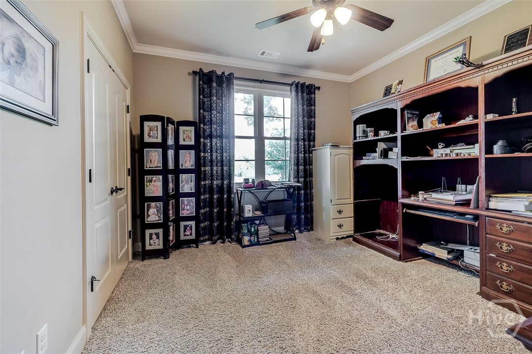 guest bedroom on the main floor tucked down a private hallway with a private bathroom right next to it
