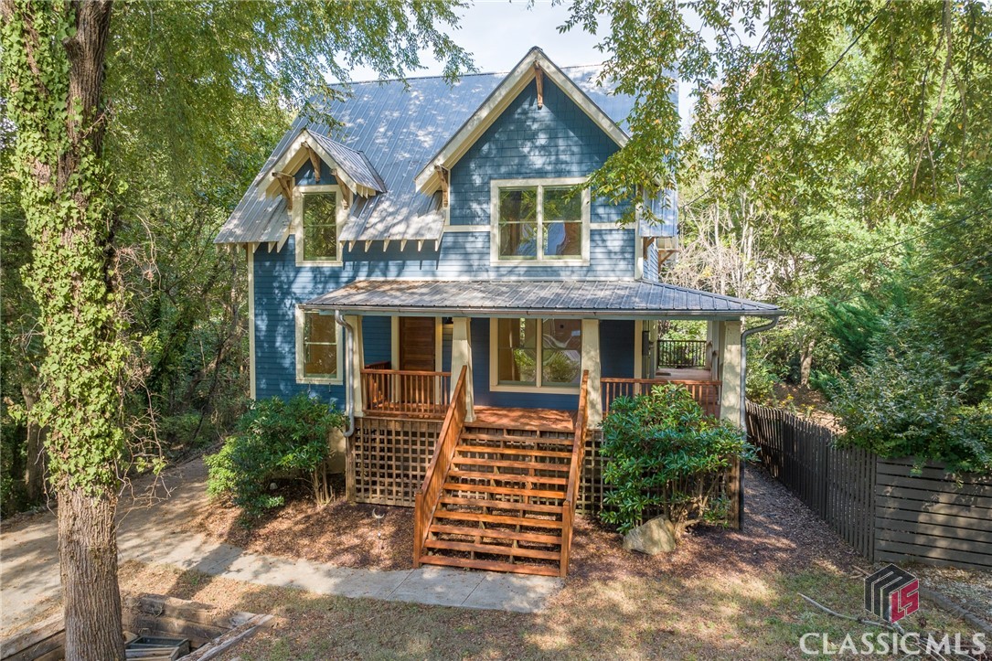 Welcome to 135 Hendrix Avenue, nestled in the heart of Pulaski Heights, a quirky and beloved Athens neighborhood known for its rich music history (think R.E.M.’s "Shiny Happy People.”) This genuine Craftsman cottage, perched on a private quarter-acre lot, offers the rarest unicorn of charm, contemporary design, and prime location.The main floor greets you with newly refinished heart pine floors, playful black-and-white accent tiles, and fresh neutral paint. With three bedrooms and three full bathrooms, including two generously sized upstairs suites with new carpet, this home is move-in ready. An unfinished, encapsulated basement with a single-car garage and separate exterior door provides ample storage and room for future projects.The cozy kitchen is warm and inviting, featuring plenty of cabinet and counter space. Tucked away, it’s an ideal spot to enjoy a quiet morning or host a dinner party. A cheerful window above the sink overlooks the treescape, filling the space with natural light and creating a peaceful atmosphere for meal prep.The main floor bedroom offers incredible versatility. Whether you need a dedicated home office with abundant light, a wellness retreat for yoga or a creative studio, this room adapts to suit your needs—making it the perfect space to personalize.A bonus-sized primary suite upstairs offers woodlandy views, exposed rafters with cathedral ceilings, and sleek, modern dark tile for a touch of sophistication.Step onto the inviting wraparound porch, nestled beneath a canopy of trees making you feel worlds away, while being just minutes from the lively pulse of downtown. Pulaski Heights also puts you within walking distance of Prince Avenue’s best local spots—Birdie’s, Poquitos, Farm Burger, The Lark, and more. At 135 Hendrix Avenue, you’ll experience urban convenience alongside vibrant art, culture, and a community that makes Athens such a unique place to call home.