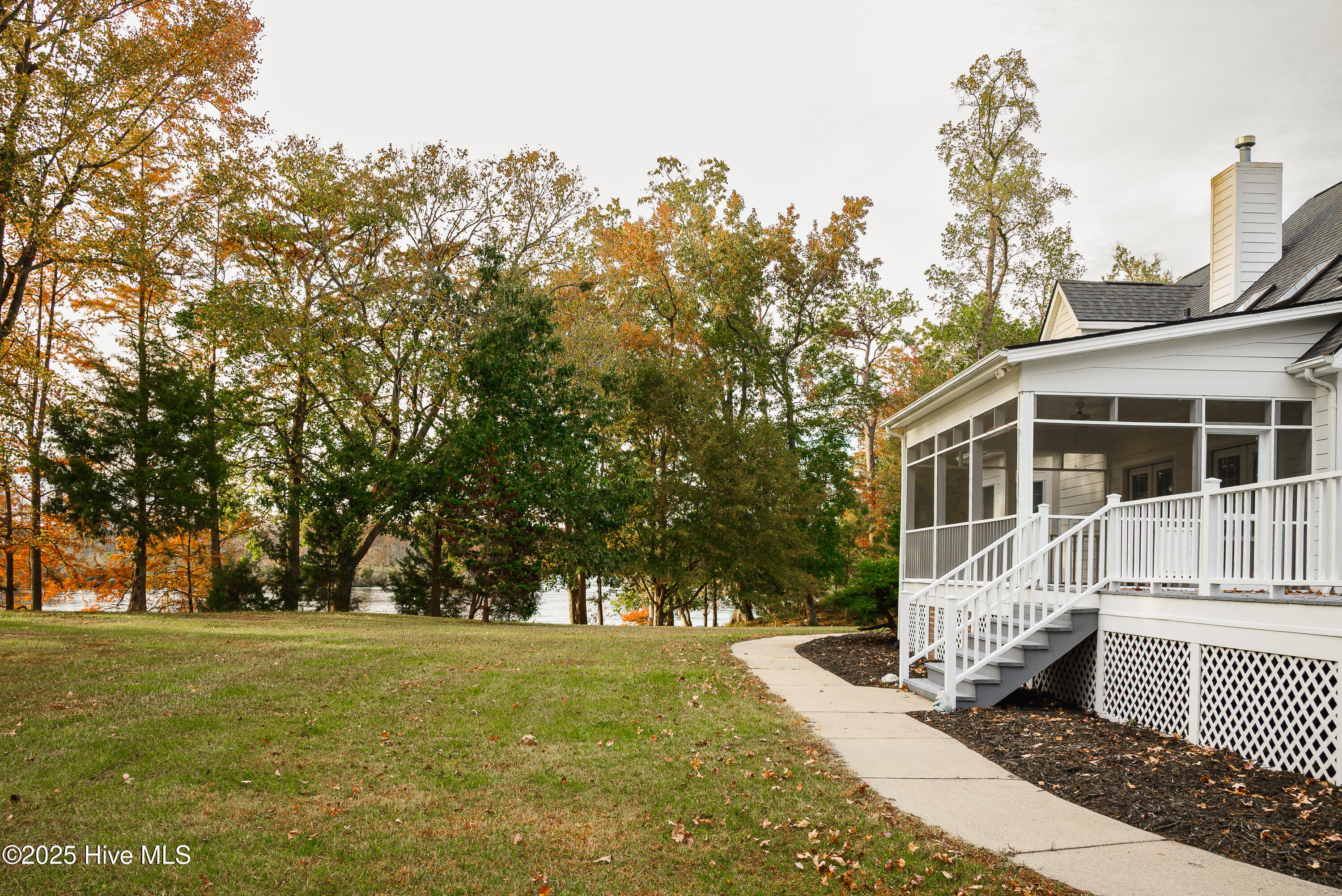 Main home with river views from primary suite, family room, other kitchen/dining, porch and deck.
