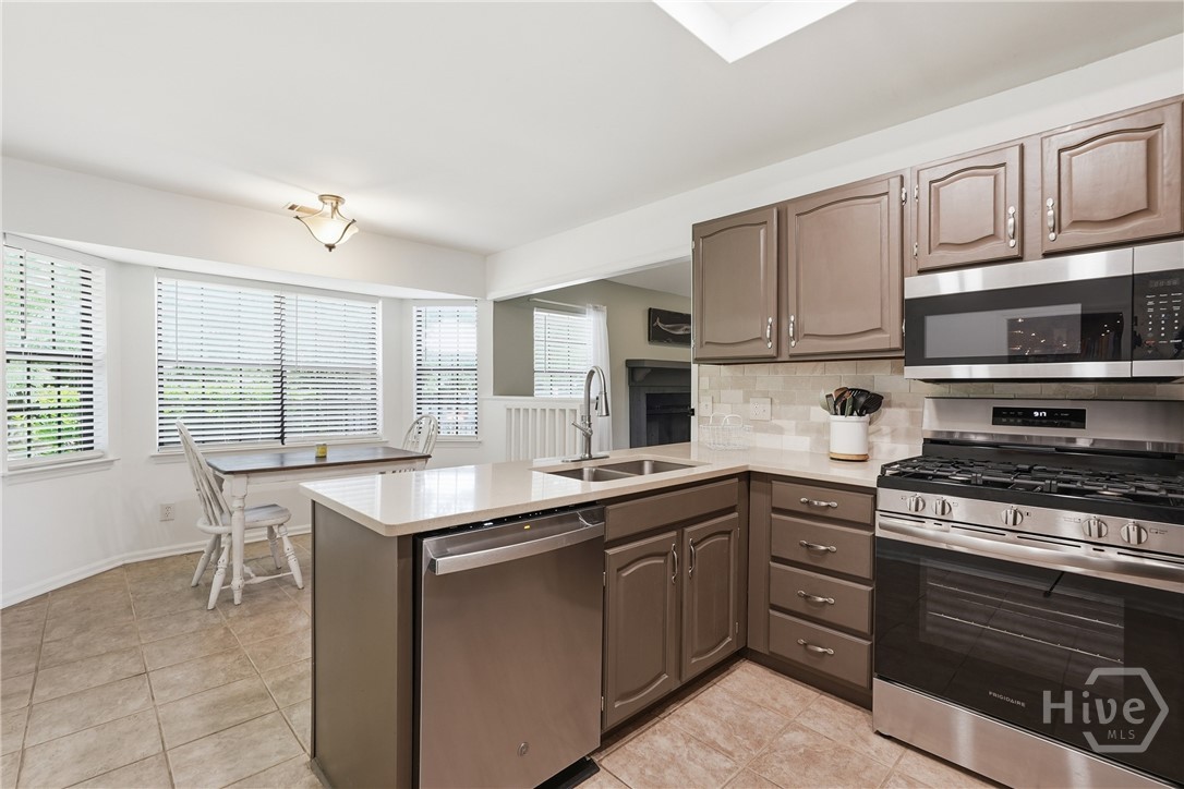 Kitchen includes a cozy and bright breakfast nook.