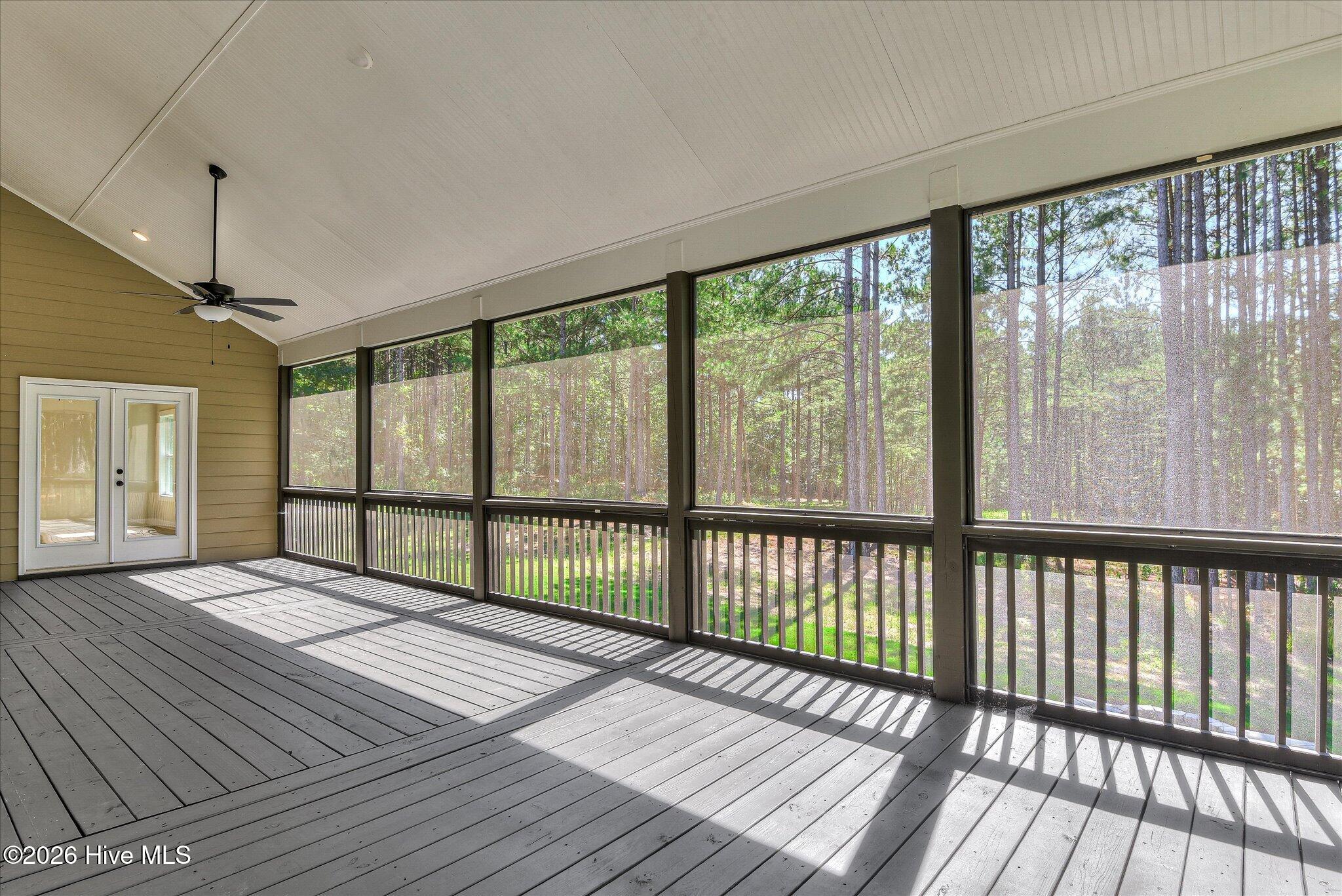 Rear screened porch stretches down the right side and across the back of the home.