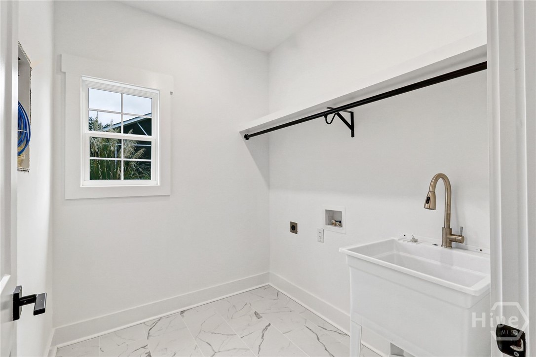 Laundry room complete with wash basin.