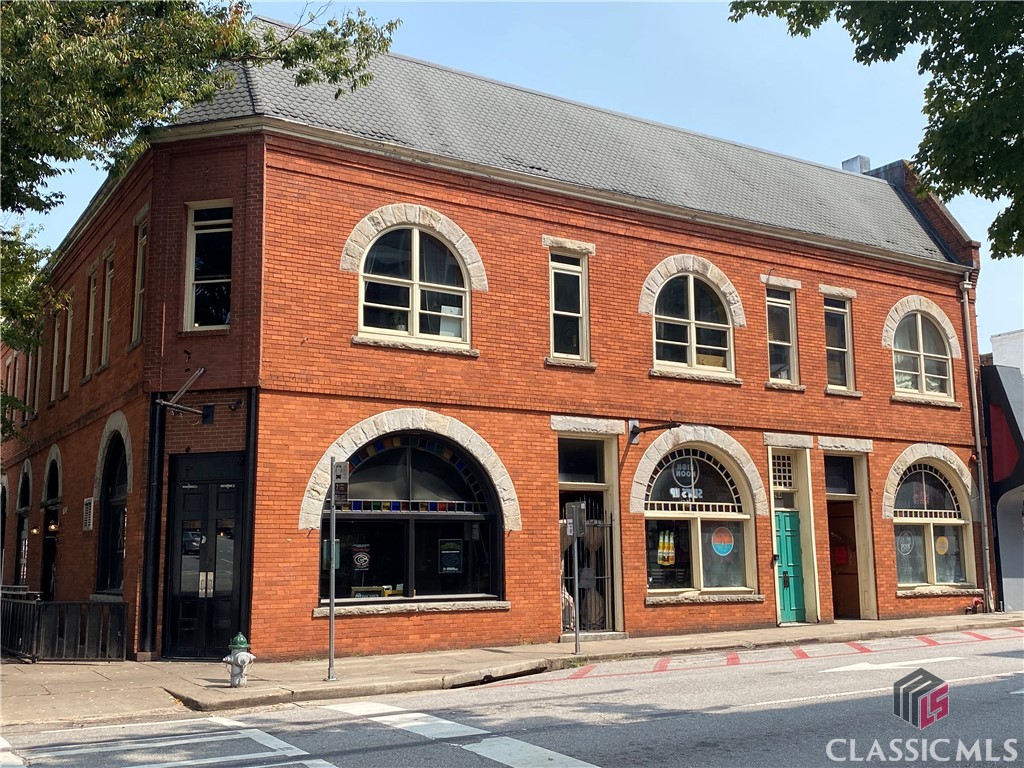 Super unique opportunity to own a historic condo in the heart of Athens located in The Observer Building, which is conveniently located at the corner of W. Washington Street and N. Lumpkin, directly across from the iconic Georgia Theatre. A rare 3 bedroom opportunity downtown, this corner condo has impressive 14' ceilings and huge arched windows that overlook downtown Athens. There is crown molding throughout, hardwood floors and great natural lighting with brick accents that give it the loft / historic feel but with modern improvements. The kitchen has granite counter tops, black appliances, and dark stained cabinets. The large master suite features spacious closets, brick accent wall and attached bath. Just down the hallway are two large additional bedrooms and one bath. Laundry Closet. Tenant Occupied.